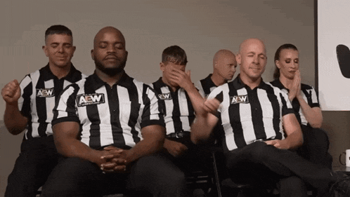 a group of men wearing aew striped shirts