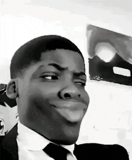 a man in a suit and tie is making a funny face in a black and white photo .