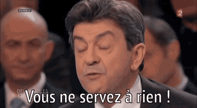 a man in a suit and tie is saying " vous ne servez a rien "