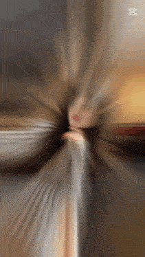 a blurry picture of a person 's face with the letter m in the corner
