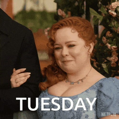 a woman in a blue dress with the word tuesday on the bottom right