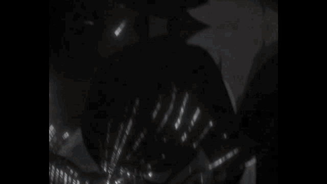 a close up of a person 's face with blue eyes glowing in the dark