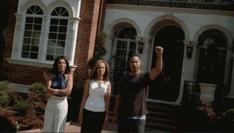 a group of people are standing in front of a brick building