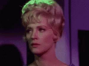 a close up of a woman 's face in a purple room .