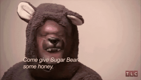 a man in a teddy bear costume is saying come give sugar bear some honey