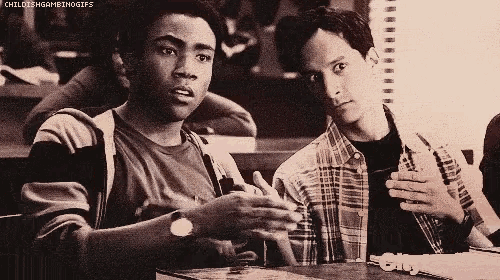 a black and white photo of two men sitting at a table