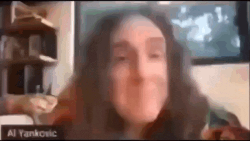 a woman is talking on a video call with a name tag that says al yankovic