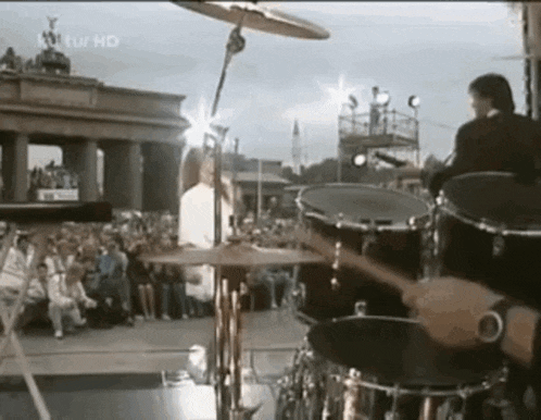 a man is playing drums in front of a crowd and the words kultur hd are on the bottom