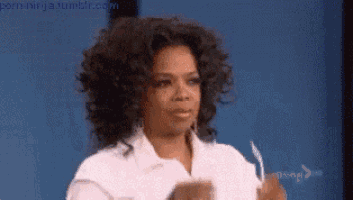 a woman with curly hair is wearing a white shirt and holding a piece of paper .
