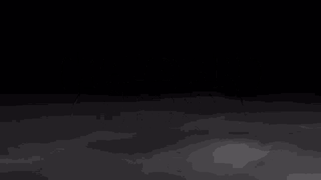 a black and white logo for graveyard shift with a cloudy sky in the background