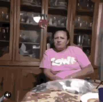 a woman wearing a pink shirt with the word swift on it