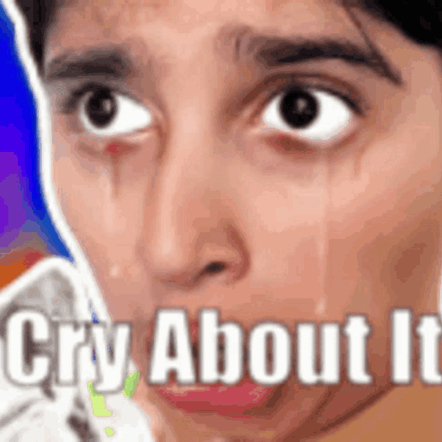 a close up of a person 's face with a tear coming out of their eye .
