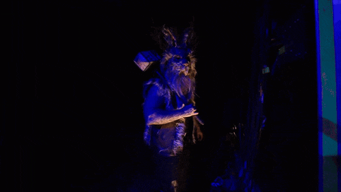 a person in a rabbit costume is holding a sign that says help
