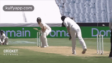 a cricket game is being played on a field with advertisements for kulfyapp.com