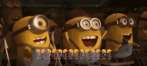 a group of minions are standing next to each other and smiling