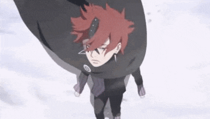 a person with red hair is standing in the snow with a black cape on .