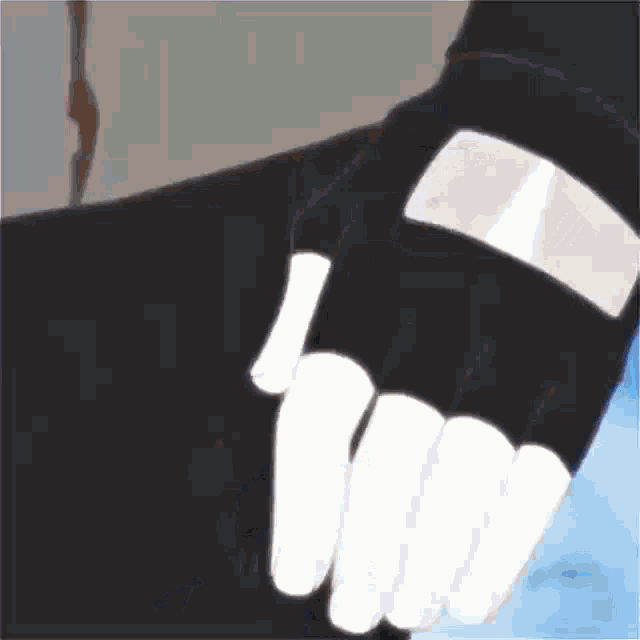 a close up of a person 's hand wearing a black glove with white fingers .