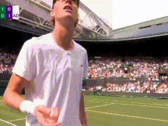 a man in a white shirt stands on a tennis court in front of a crowd and a scoreboard that says 1 0 1 ad