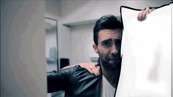 a man in a leather jacket is holding a white sheet of paper