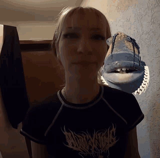 a woman wearing a black shirt that says ' dawnwind ' on the front