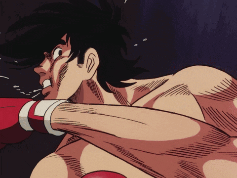 a man in boxing gloves is getting ready to punch another man