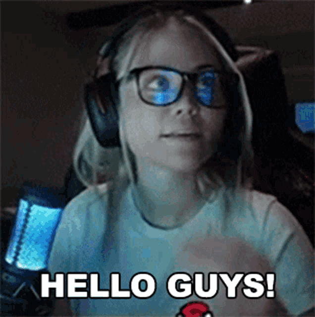 a girl wearing headphones says hello guys