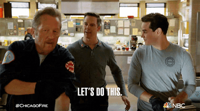 three men are standing in a kitchen and one says let 's do this