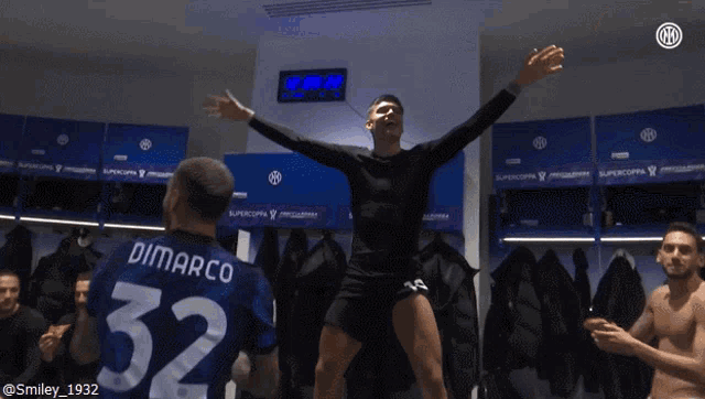 a man in a dimarco 32 jersey is dancing in a locker room