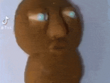 a close up of a potato with a face and blue eyes .