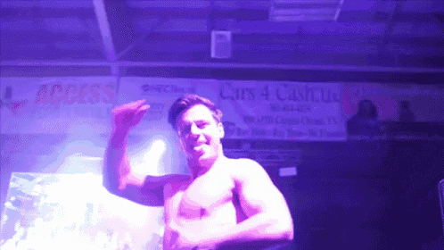 a man without a shirt is dancing in front of a sign that says cars 4 cash llc