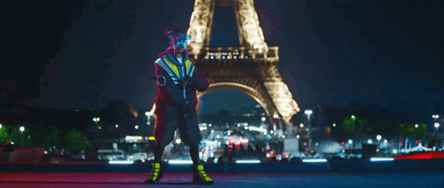 the eiffel tower is lit up at night in the background