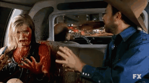 a man in a cowboy hat is talking to a bloody woman in a car with fx written on the bottom