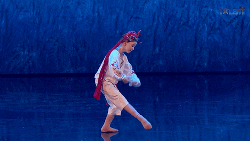 a young boy is dancing on a stage with the word talent on the bottom right