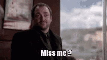 a man in a suit and tie is standing in front of a window and saying `` miss me '' .