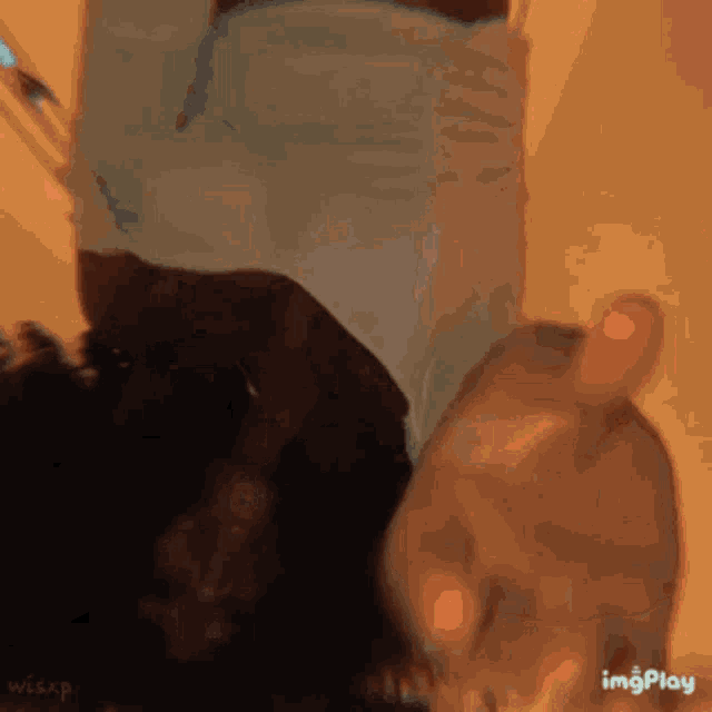 a person is laying on their back with their head upside down and a hand reaching out towards them .