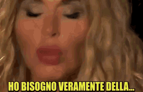 a close up of a woman 's face with the words ho bisogno veramente della written above her