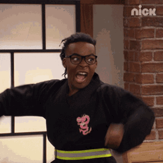 a man wearing glasses and a black shirt with a dragon on it
