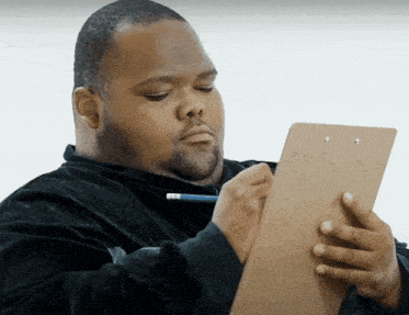 a man holding a clipboard and a pencil