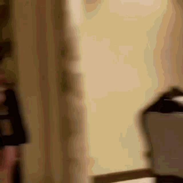 a blurry picture of a person standing in a room with a lamp .