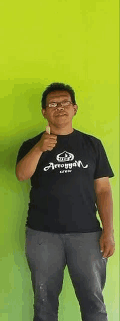 a man wearing a t-shirt that says arroyyan crew is giving a thumbs up