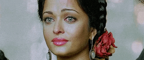a close up of a woman with a flower in her hair .