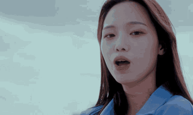 a close up of a woman 's face with her mouth wide open