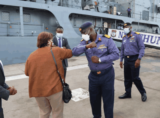 a man in a purple uniform with a badge that says ' nigerian navy ' on it