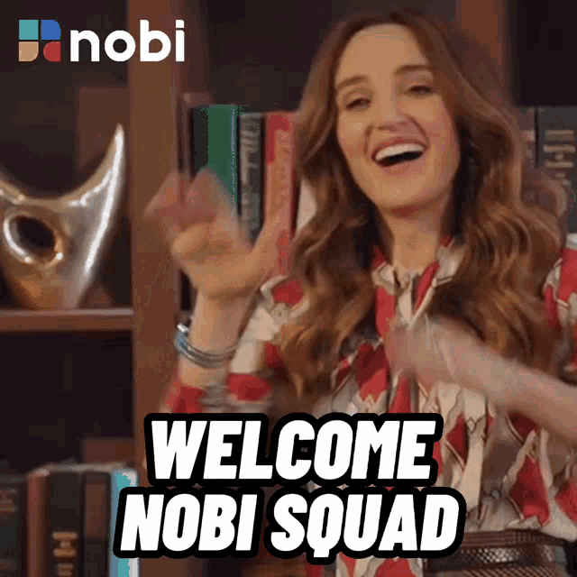a woman says welcome nobi squad in front of a book shelf