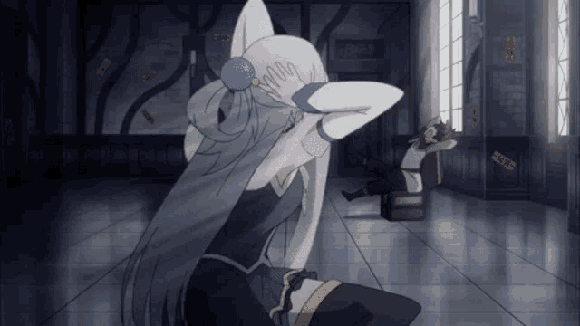 a man sits on a box while a woman holds her head