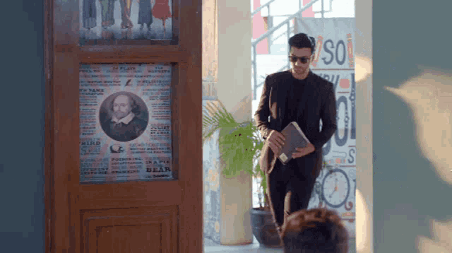 a man standing in front of a sign that says ' so '