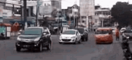 a blurry picture of cars driving down a street in a city .