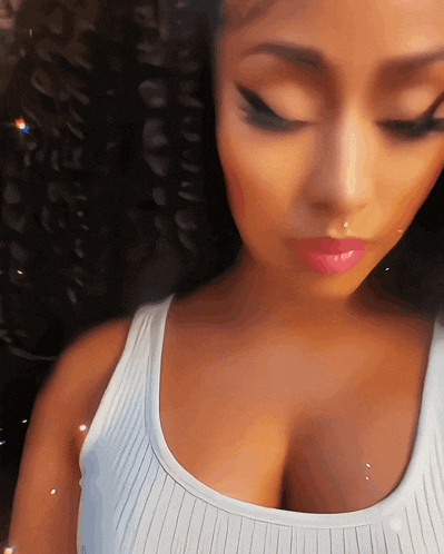 a close up of a woman 's face and breasts