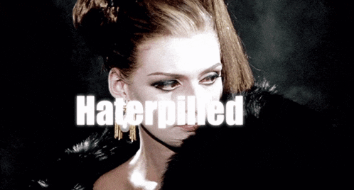 a woman wearing a fur coat with the word haterpilled on it