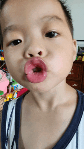 a little boy making a funny face with his mouth open